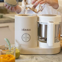 Person using a BEABA baby food in a kitchen setting